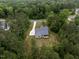 Aerial view of a beautiful home nestled among lush green trees, offering a sense of privacy and tranquility at 200 Whistlers Cv, Louisburg, NC 27549