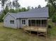 Backyard view of a home featuring a wooden deck and screened-in porch perfect for outdoor relaxation at 200 Whistlers Cv, Louisburg, NC 27549