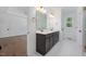 An elegant double sink bathroom vanity featuring marble countertops, modern fixtures, and tile flooring at 200 Whistlers Cv, Louisburg, NC 27549