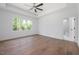 A bright, spacious bedroom features tray ceiling, large windows, and luxurious hardwood flooring at 200 Whistlers Cv, Louisburg, NC 27549