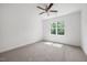 Bedroom with neutral carpeting, ceiling fan, and a window for natural light at 200 Whistlers Cv, Louisburg, NC 27549