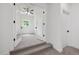 Bedroom located off an entryway, with neutral carpeting, ceiling fan, and a window at 200 Whistlers Cv, Louisburg, NC 27549