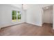 Bright bedroom with hardwood floors and a window overlooking a wooded backyard at 200 Whistlers Cv, Louisburg, NC 27549