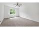 Bedroom with neutral carpeting, ceiling fan, and a window for natural light at 200 Whistlers Cv, Louisburg, NC 27549