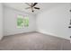 Bright, carpeted bedroom with white walls, a ceiling fan and natural light from a window at 200 Whistlers Cv, Louisburg, NC 27549