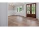 Formal dining room with wood floors and natural light from a large window at 200 Whistlers Cv, Louisburg, NC 27549