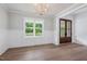 Dining room with wood floors, a chandelier, and a large window at 200 Whistlers Cv, Louisburg, NC 27549