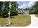 Beautiful two-story home with a well-manicured lawn and an inviting front entrance and a long driveway at 200 Whistlers Cv, Louisburg, NC 27549
