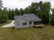 Back exterior view of the home with a screened porch and natural surroundings at 200 Whistlers Cv, Louisburg, NC 27549