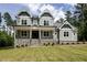 Charming home featuring stone accents, a welcoming front porch, and a beautifully landscaped yard at 200 Whistlers Cv, Louisburg, NC 27549