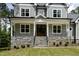 Charming home exterior featuring a stone foundation and front porch with steps leading to a welcoming entrance at 200 Whistlers Cv, Louisburg, NC 27549