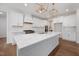 Modern kitchen with white cabinets, stainless steel appliances, and a large island at 200 Whistlers Cv, Louisburg, NC 27549