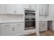 Modern kitchen featuring stainless steel microwave and oven, quartz countertops, and white cabinets at 200 Whistlers Cv, Louisburg, NC 27549