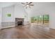 Spacious living room featuring a stone fireplace and access to the outdoor patio at 200 Whistlers Cv, Louisburg, NC 27549