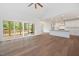 Open living space featuring hardwood floors, vaulted ceilings, modern lighting, and sliding glass doors to the porch at 200 Whistlers Cv, Louisburg, NC 27549