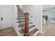 Elegant staircase with wood treads, black iron spindles and white risers for a modern look at 200 Whistlers Cv, Louisburg, NC 27549