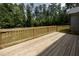 Spacious wooden deck perfect for outdoor gatherings and relaxation and features wooden railings at 200 Whistlers Cv, Louisburg, NC 27549