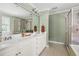 Bright bathroom with double sink vanity, large mirror, walk-in shower, and garden window at 204 Towne Ridge Ln, Chapel Hill, NC 27516