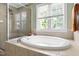 Bright bathroom featuring a walk-in shower, soaking tub and garden window at 204 Towne Ridge Ln, Chapel Hill, NC 27516