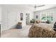 Cozy bedroom showcasing a bright window, plants and neutral furnishings at 204 Towne Ridge Ln, Chapel Hill, NC 27516