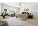 Bright bedroom featuring a ceiling fan, window and brown patterned bedding at 204 Towne Ridge Ln, Chapel Hill, NC 27516
