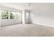 A bright, empty room with carpeted flooring and large windows at 204 Towne Ridge Ln, Chapel Hill, NC 27516