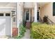 Welcoming townhouse entrance with brick stairs, garden, and modern outdoor lighting creating a warm ambiance at 204 Towne Ridge Ln, Chapel Hill, NC 27516
