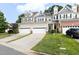 Inviting townhouse featuring attached garages, a well-manicured lawn, and attractive curb appeal in a lovely neighborhood at 204 Towne Ridge Ln, Chapel Hill, NC 27516