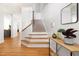 Elegant foyer with hardwood floors, staircase, and tastefully decorated console table at 204 Towne Ridge Ln, Chapel Hill, NC 27516