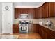 Gourmet kitchen featuring stainless steel appliances, granite countertops, and modern finishes at 204 Towne Ridge Ln, Chapel Hill, NC 27516