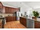 Elegant kitchen with stainless steel appliances, granite countertops, and seamless flow to the living area at 204 Towne Ridge Ln, Chapel Hill, NC 27516