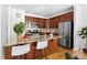 Modern kitchen with granite countertops, stainless steel appliances, and stylish breakfast bar seating at 204 Towne Ridge Ln, Chapel Hill, NC 27516
