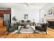 Well-appointed living room with hardwood floors, fireplace, modern furniture, and ample natural light at 204 Towne Ridge Ln, Chapel Hill, NC 27516