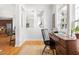 Well-lit office featuring a wooden desk, natural light, and seamless flow to living and kitchen areas at 204 Towne Ridge Ln, Chapel Hill, NC 27516