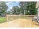 Wood deck overlooking fenced-in yard and mature trees at 204 Valley Ct, Selma, NC 27576