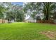 Fenced-in backyard with mature trees and deck at 204 Valley Ct, Selma, NC 27576