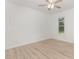 This empty bedroom features a ceiling fan, laminate floors, and a window at 204 Valley Ct, Selma, NC 27576