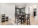 Bright dining area adjacent to kitchen, featuring a dark wood table, chairs, and light wood-look floors at 204 Valley Ct, Selma, NC 27576