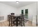 Inviting dining area with a dark wood table set, and double doors leading to the backyard at 204 Valley Ct, Selma, NC 27576