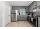 Updated kitchen featuring stainless appliances, gray cabinets, granite countertops and stylish backsplash at 204 Valley Ct, Selma, NC 27576