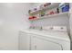 Laundry room features white washer and dryer and white walls at 204 Valley Ct, Selma, NC 27576