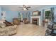 Bright living room featuring blue walls, wood-look floors, a fireplace, and comfortable seating at 204 Valley Ct, Selma, NC 27576