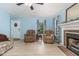 Cozy living room with blue walls, light floors, fireplace and large windows providing natural light at 204 Valley Ct, Selma, NC 27576