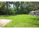 Spacious backyard with green grass, shed, and a wooden fence at 205 Cedar Dr, Zebulon, NC 27597