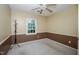 An empty bedroom with brown and beige walls, carpeted floor and a ceiling fan at 205 Cedar Dr, Zebulon, NC 27597