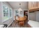 Cozy dining area with wood table and chairs, bright natural light, creating a warm atmosphere at 205 Cedar Dr, Zebulon, NC 27597