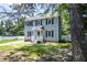Charming two-story home with a well-manicured lawn, classic shutters, and inviting front porch at 205 Cedar Dr, Zebulon, NC 27597