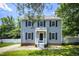 Attractive two-story home with a front yard and a walkway leading to the entrance at 205 Cedar Dr, Zebulon, NC 27597