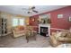 Cozy living room with fireplace, a ceiling fan, and neutral-toned walls at 205 Cedar Dr, Zebulon, NC 27597