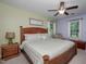 A bright main bedroom with a ceiling fan and wooden furniture at 205 Cedar Dr, Zebulon, NC 27597